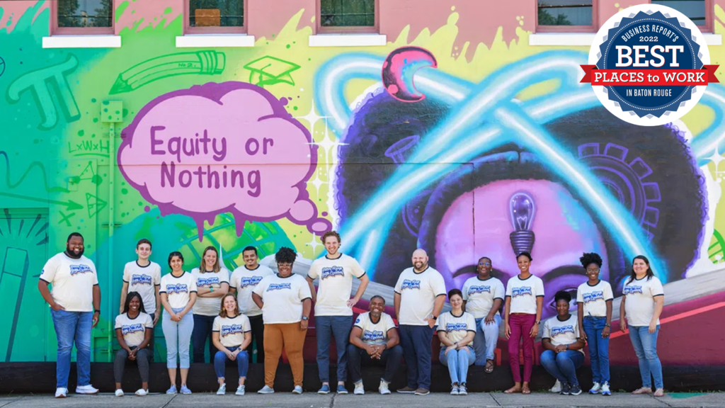 BRYC team members gather in front of the mural