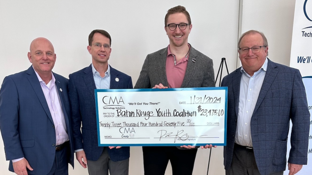 Lucas Spielfogel accepts check from CMA Technology Solutions team
